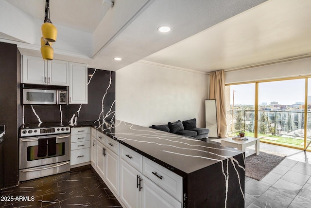 kitchen featuring stainless steel appliances, white cabinetry, decorative backsplash, and kitchen peninsula