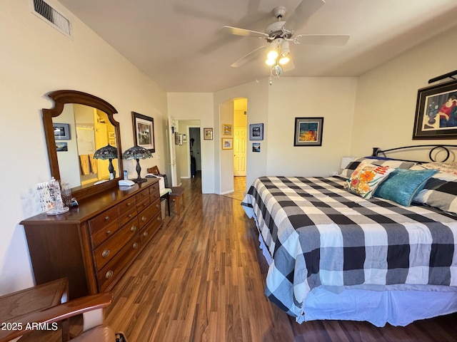 bedroom with dark hardwood / wood-style flooring and ceiling fan