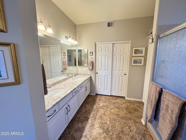 bathroom featuring vanity and a shower with shower door