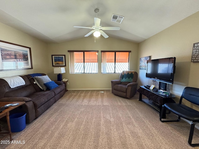 living room with lofted ceiling, ceiling fan, and carpet flooring