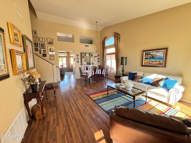 living room with high vaulted ceiling and hardwood / wood-style floors