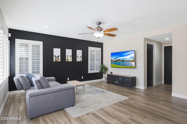 living room featuring hardwood / wood-style flooring and ceiling fan