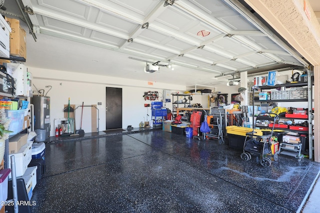 garage with a garage door opener, electric water heater, and a workshop area