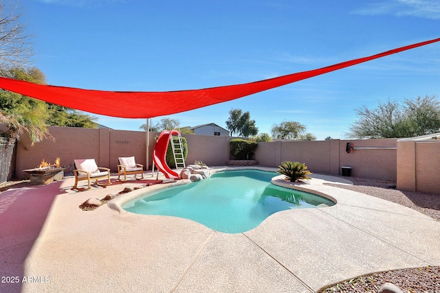 view of swimming pool with a water slide and a patio