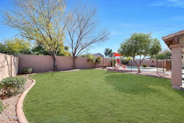 view of yard featuring a fenced in pool