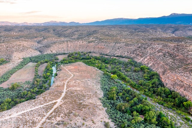 aerial view at dusk featuring a mountain view