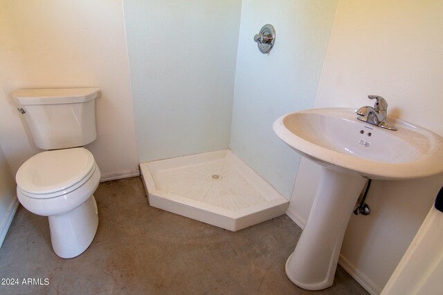 bathroom with toilet and walk in shower