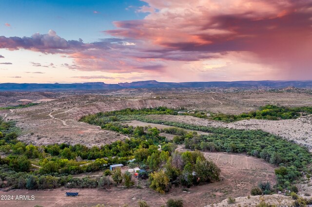 aerial view at dusk featuring a mountain view