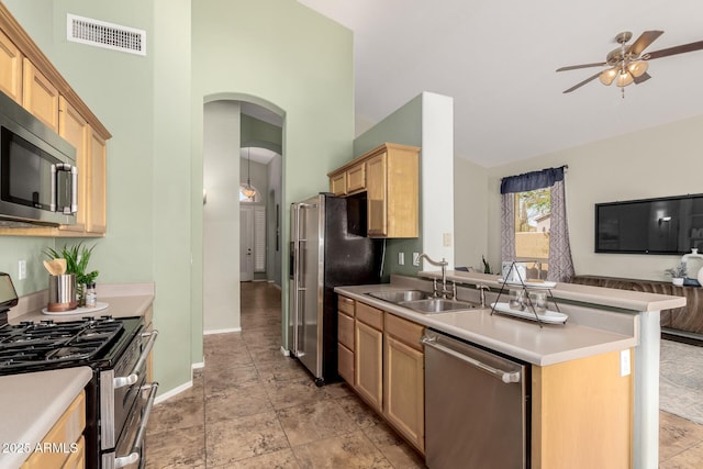 3055 N Red Mtn Unit 77, Mesa, AZ 85207 - kitchen featuring stainless steel appliances, a sink, arched walkways, ceiling fan, and light brown cabinets