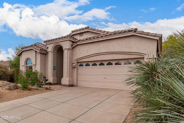 3055 N Red Mtn Unit 77, Mesa, AZ 85207 - mediterranean / spanish home featuring concrete driveway, an attached garage, stucco siding, and a tiled roof