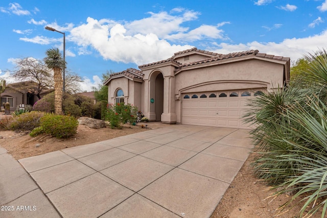 3055 N Red Mtn Unit 77, Mesa, AZ 85207 - mediterranean / spanish-style home featuring a garage, concrete driveway, stucco siding, and a tiled roof