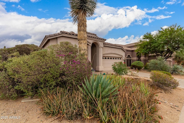 3055 N Red Mtn Unit 77, Mesa, AZ 85207 - mediterranean / spanish house featuring stucco siding, a garage, and a tile roof