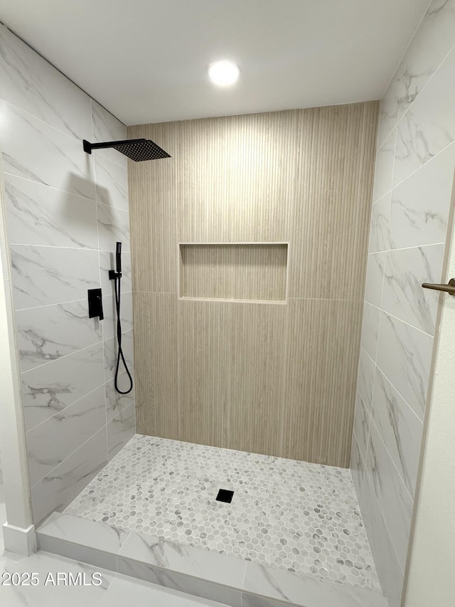 bathroom with a tile shower