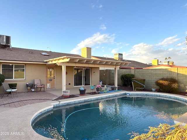 view of swimming pool featuring a pergola, central AC unit, and a patio