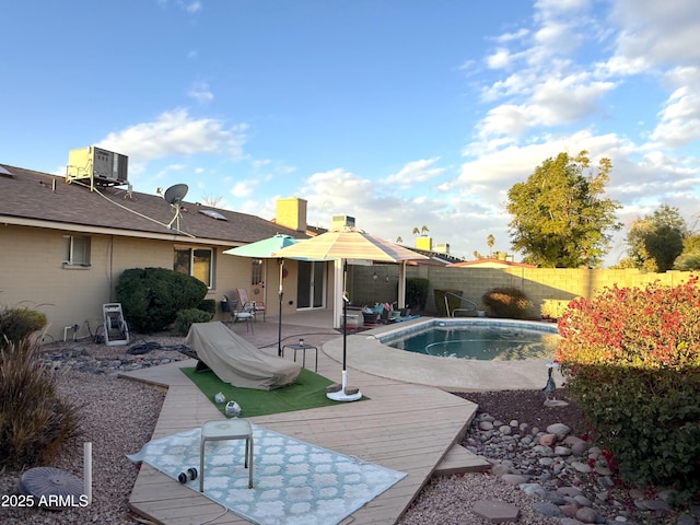 view of pool with central AC and a patio