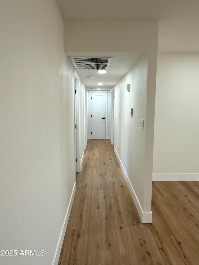 corridor with light wood-type flooring