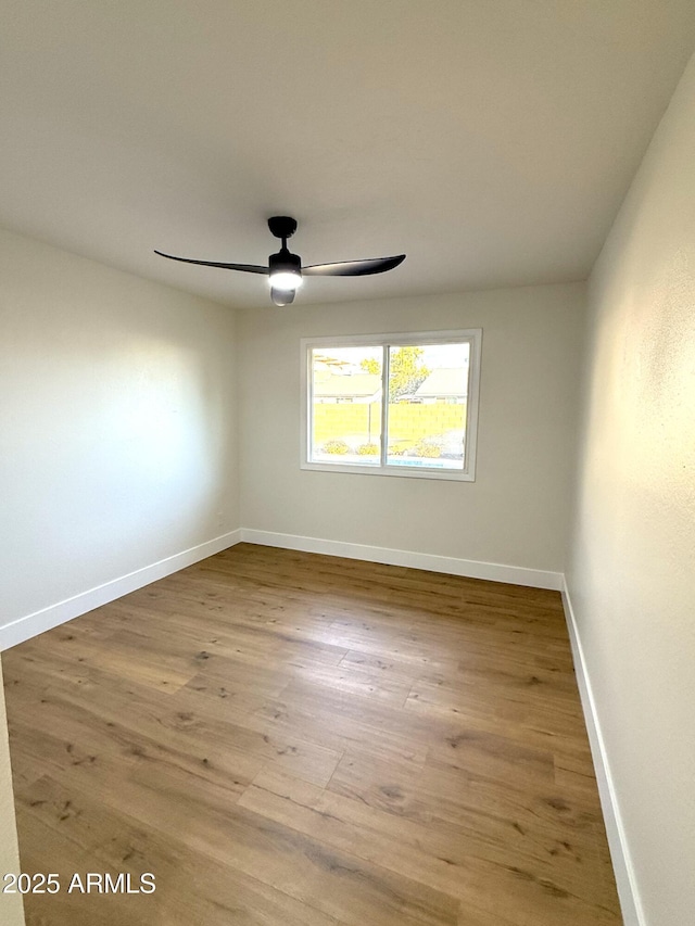 empty room with hardwood / wood-style flooring and ceiling fan