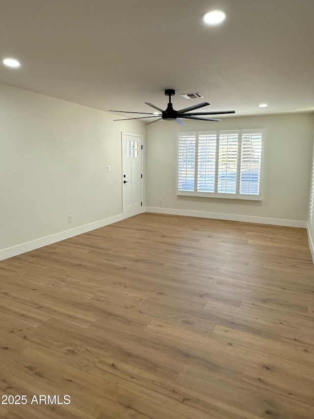 unfurnished room with ceiling fan and light hardwood / wood-style floors