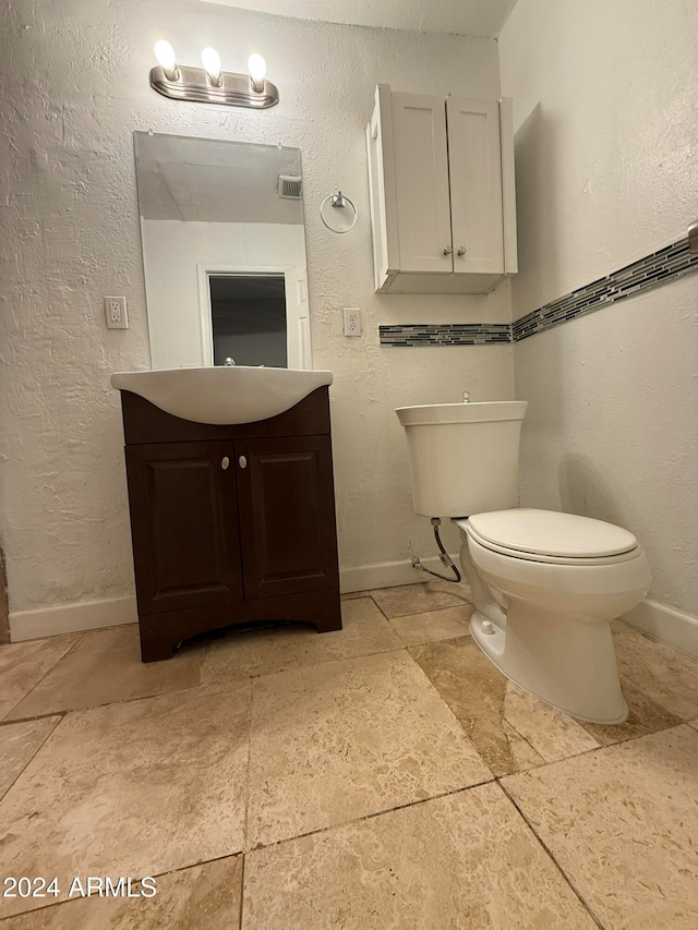 bathroom featuring vanity and toilet