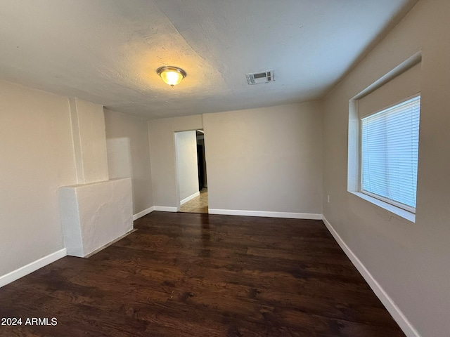 empty room featuring dark hardwood / wood-style flooring