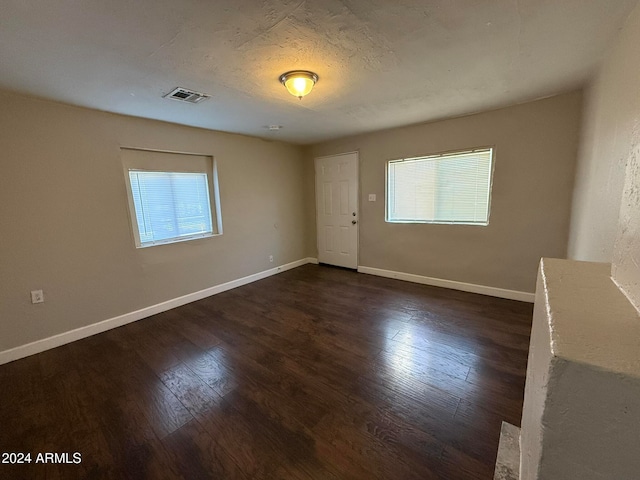 empty room featuring dark wood-type flooring