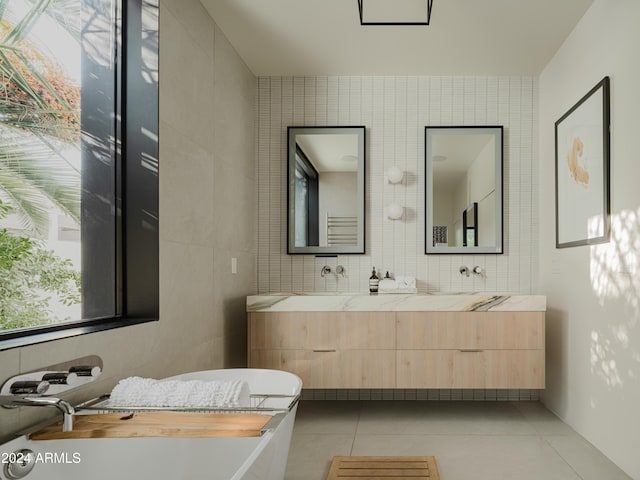 bathroom with tile patterned floors, tile walls, and vanity