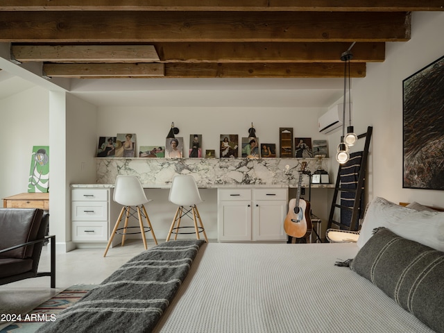 bedroom featuring beamed ceiling, a wall mounted AC, and built in desk