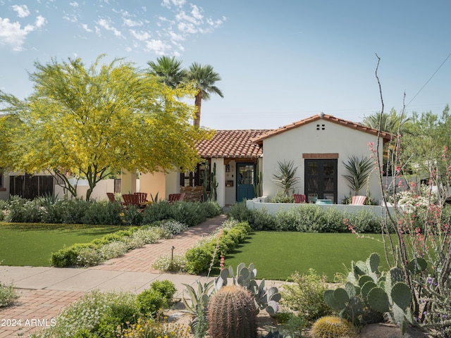 mediterranean / spanish house with a front yard