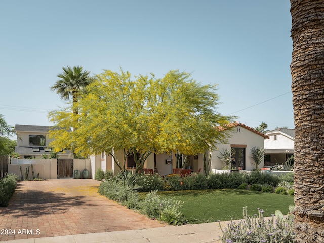 obstructed view of property featuring a front yard