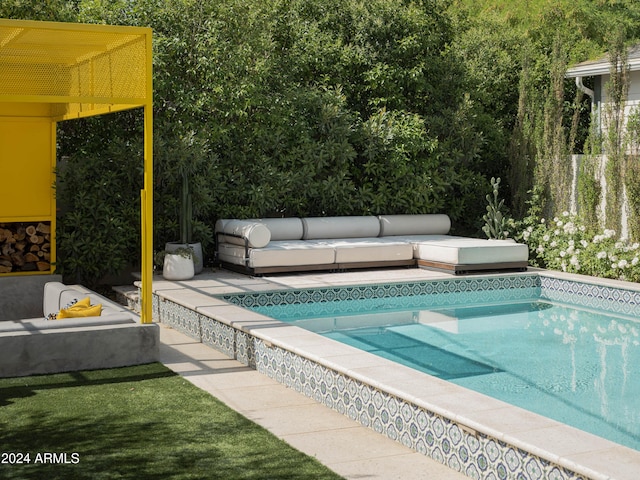 view of pool featuring an outdoor living space and a patio