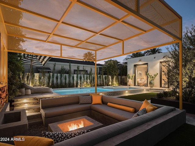 pool at dusk with an outdoor living space with a fire pit and a patio area