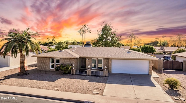 single story home featuring covered porch and a garage