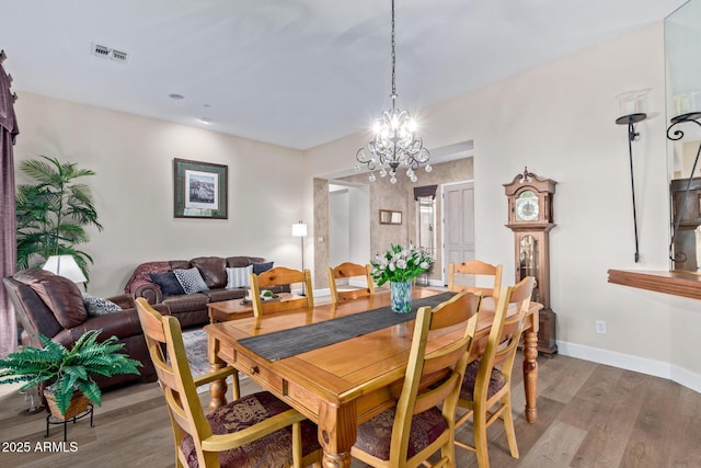 dining room featuring a notable chandelier and hardwood / wood-style flooring