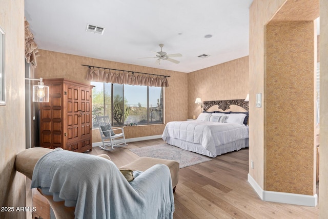 bedroom with ceiling fan and hardwood / wood-style floors