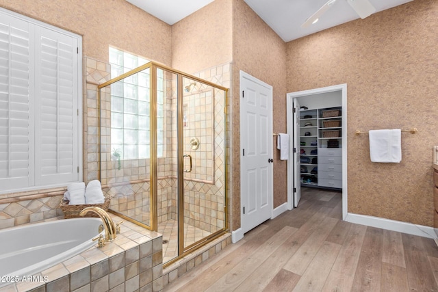 bathroom with hardwood / wood-style flooring and separate shower and tub