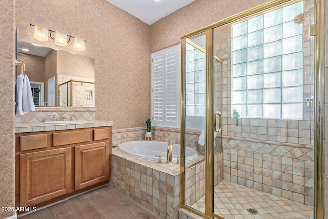 bathroom with vanity, hardwood / wood-style flooring, and independent shower and bath