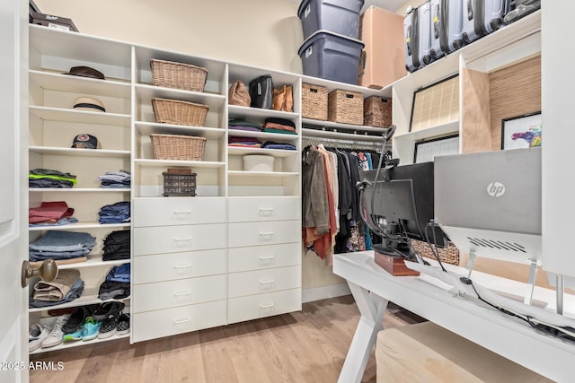 spacious closet with light hardwood / wood-style floors