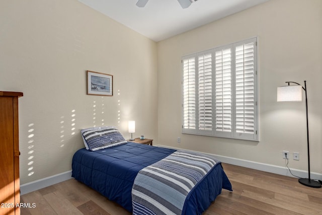 bedroom featuring hardwood / wood-style floors and ceiling fan