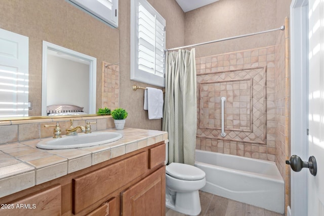 full bathroom with vanity, wood-type flooring, shower / bath combination with curtain, and toilet