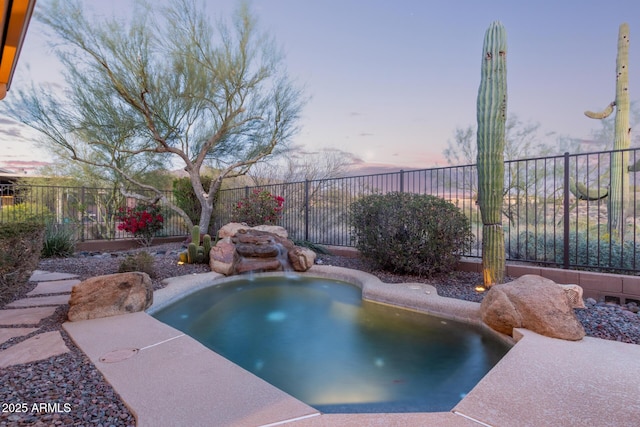 view of pool at dusk