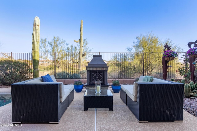 view of patio / terrace with an outdoor living space with a fireplace