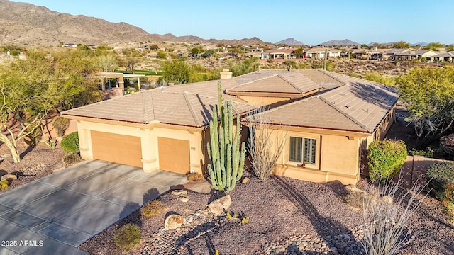 single story home with a mountain view and a garage