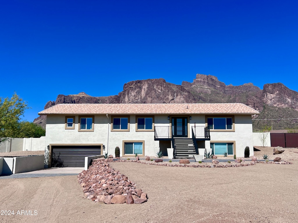 view of front of property featuring a garage and a mountain view