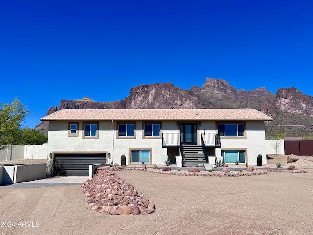 view of front of property featuring a garage and a mountain view