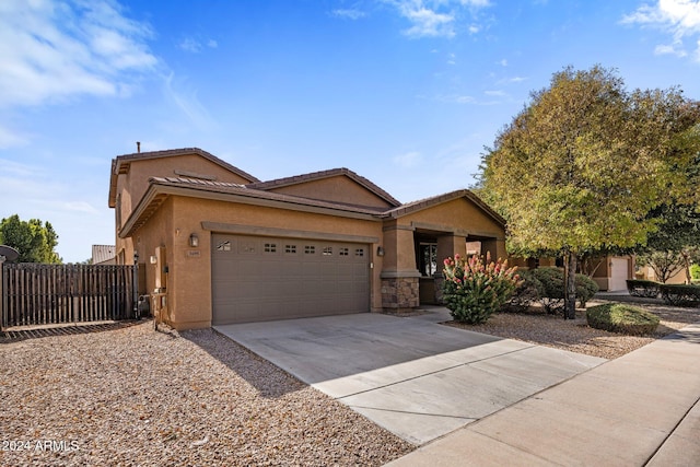 ranch-style house featuring stucco siding, driveway, a garage, and fence