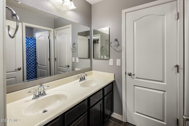 bathroom with a sink and double vanity