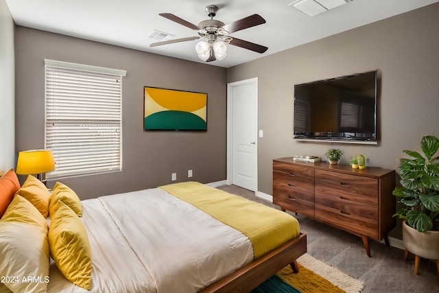 carpeted bedroom with visible vents, ceiling fan, and baseboards