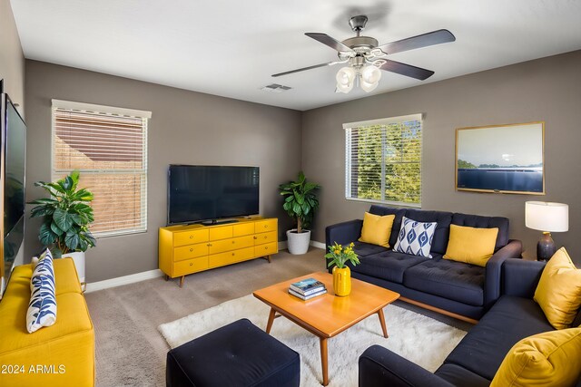 living room with visible vents, carpet flooring, a ceiling fan, and baseboards