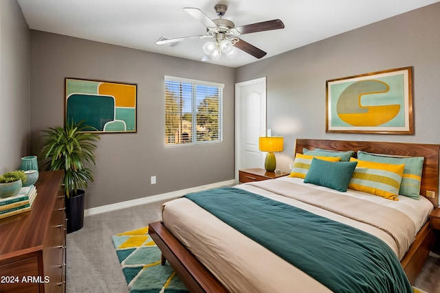 carpeted bedroom with baseboards and a ceiling fan