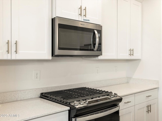 kitchen with white cabinetry and stainless steel appliances